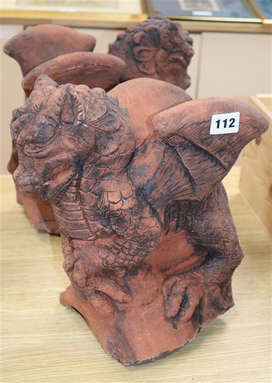 A pair of moulded terracotta griffins height 31cm